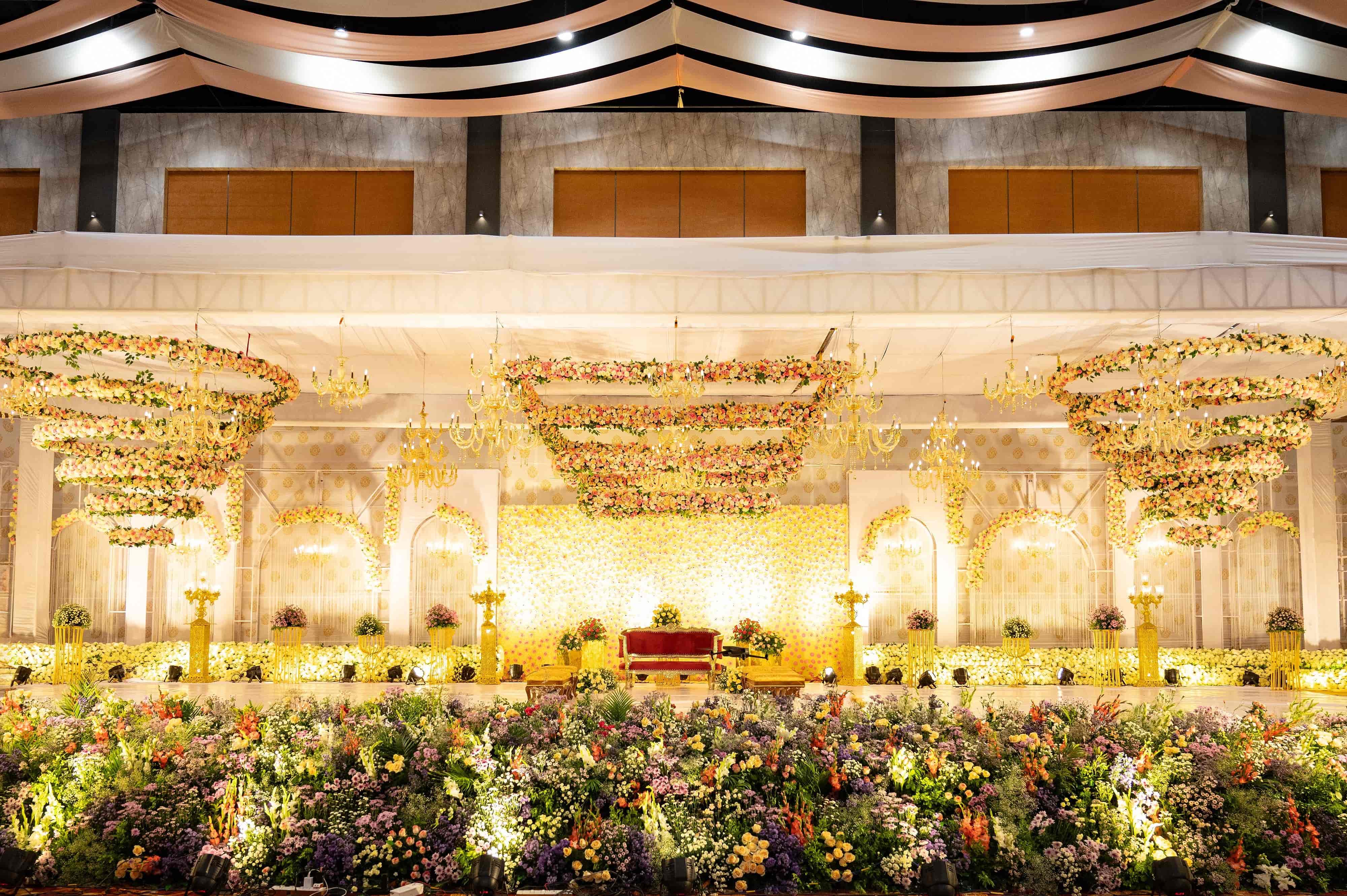 Illuminated floral wedding stage decor at VRC Convention